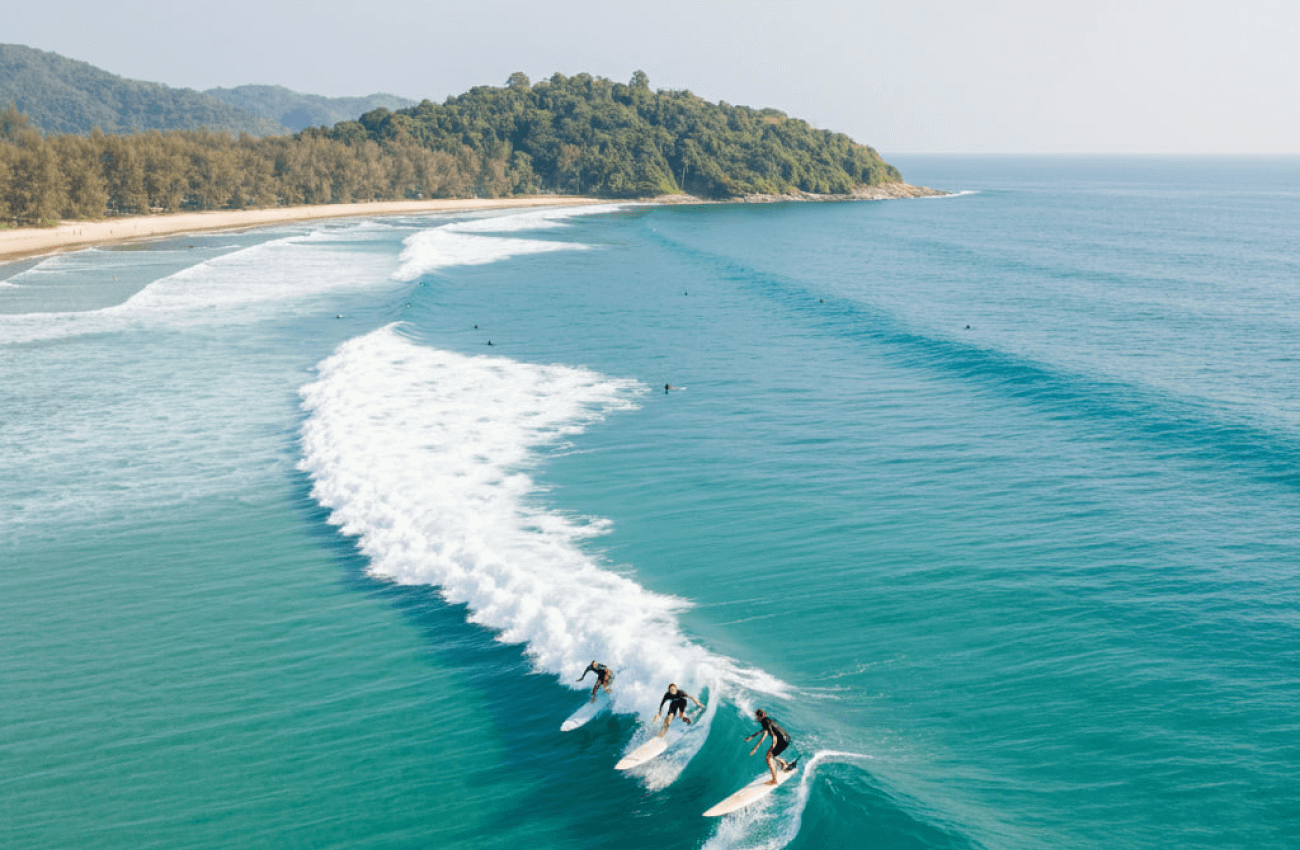 Surfing instructors teaching a group of beginners on the water