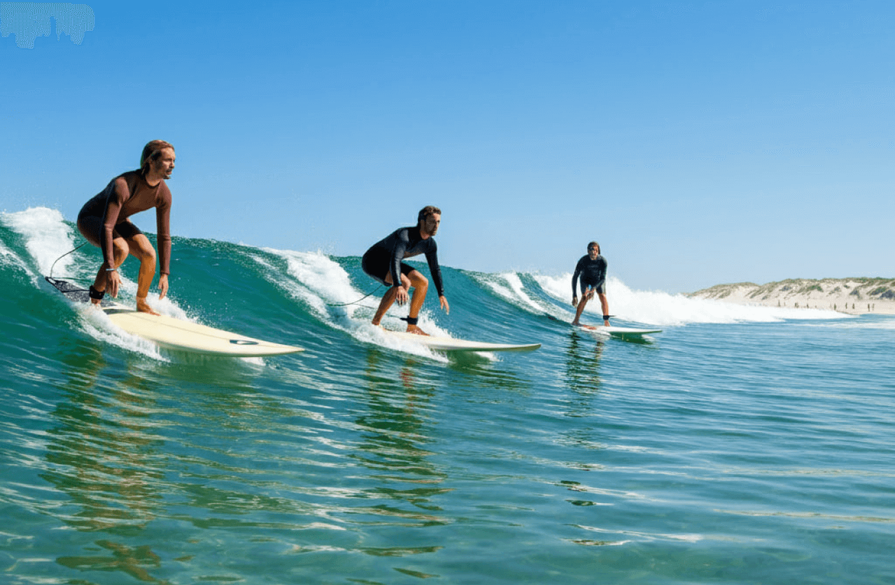 A group of people undergoing surfing training in the ocean