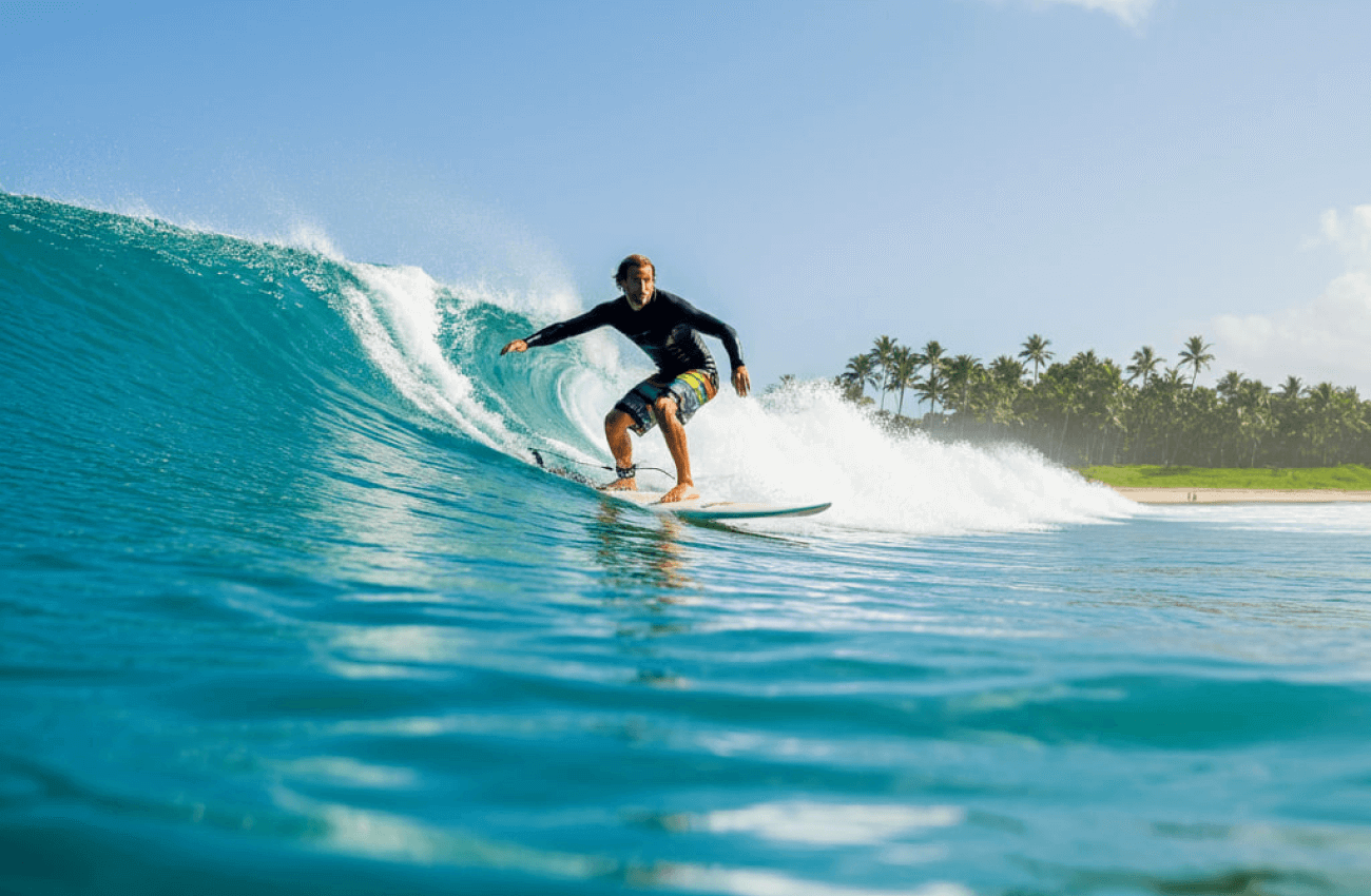 A surfer riding a perfect wave at a well-known Phuket surf spot