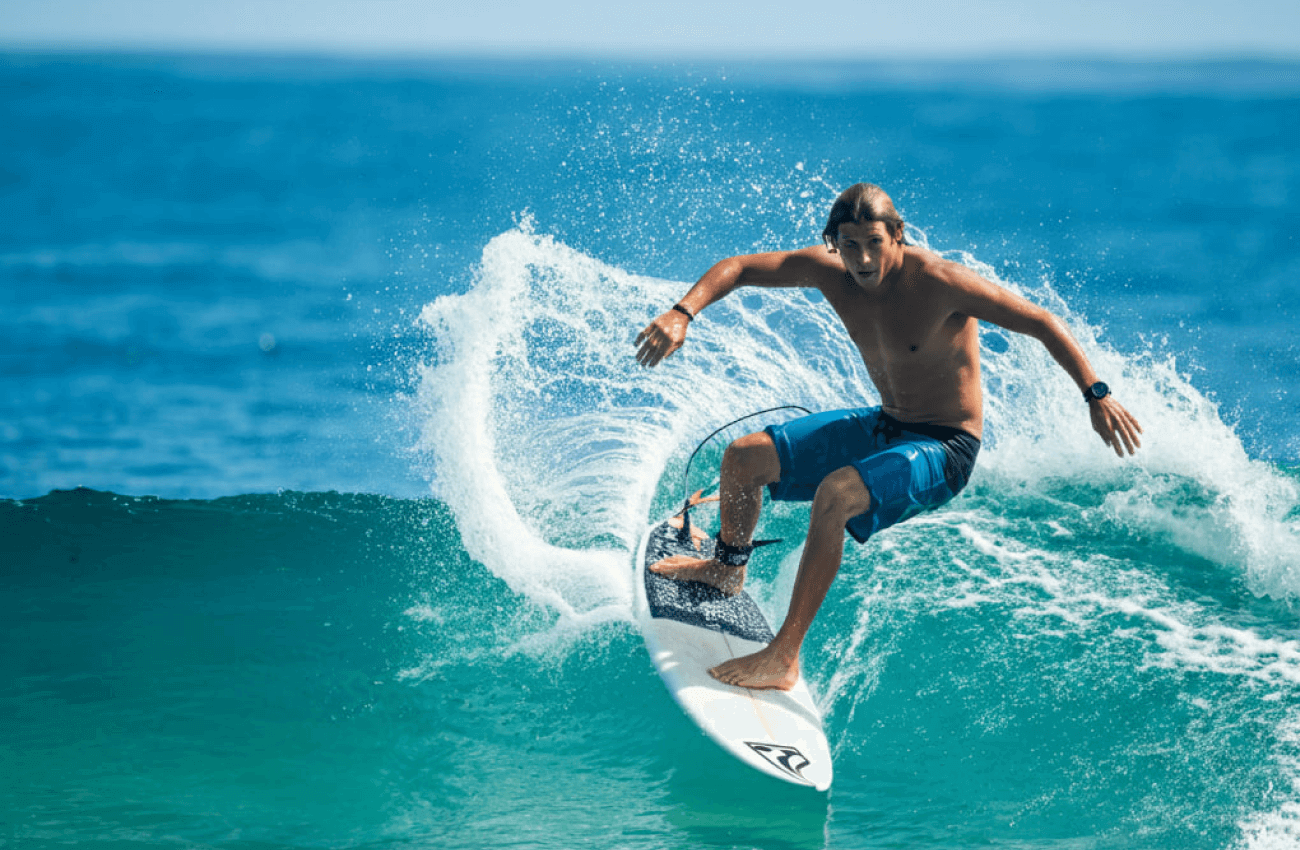A man enjoying a great day of surfing in Koh Phangan while riding a wave