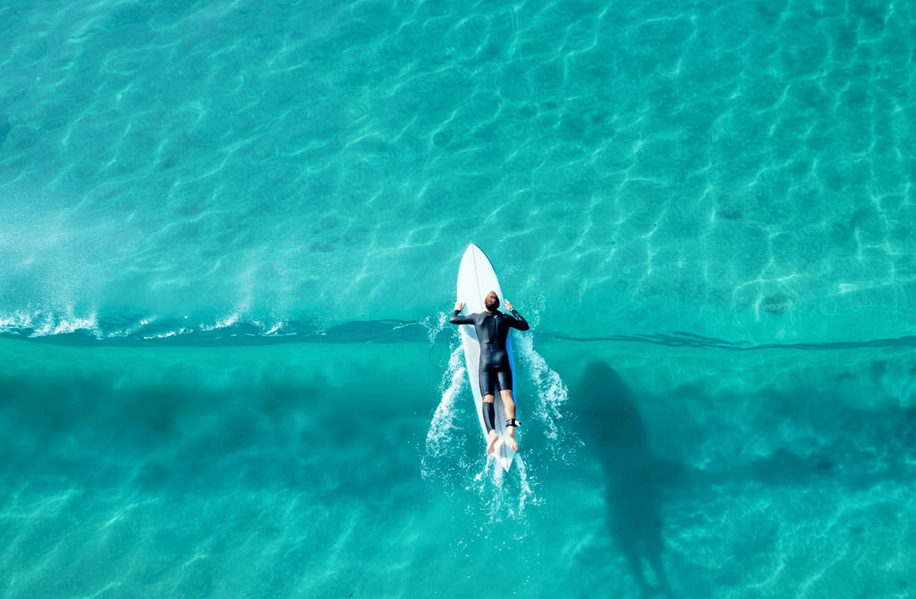 A man enjoying the ocean waves while surfing in Koh Phangan, Thailand